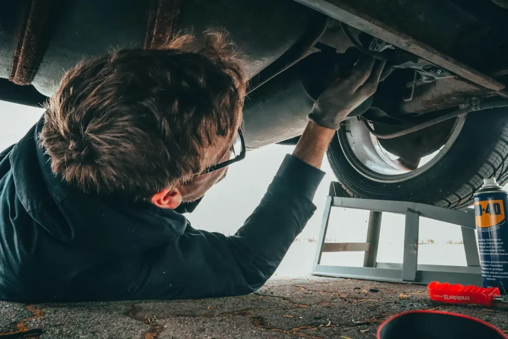 Man Fixing Vehicle After Car Accident