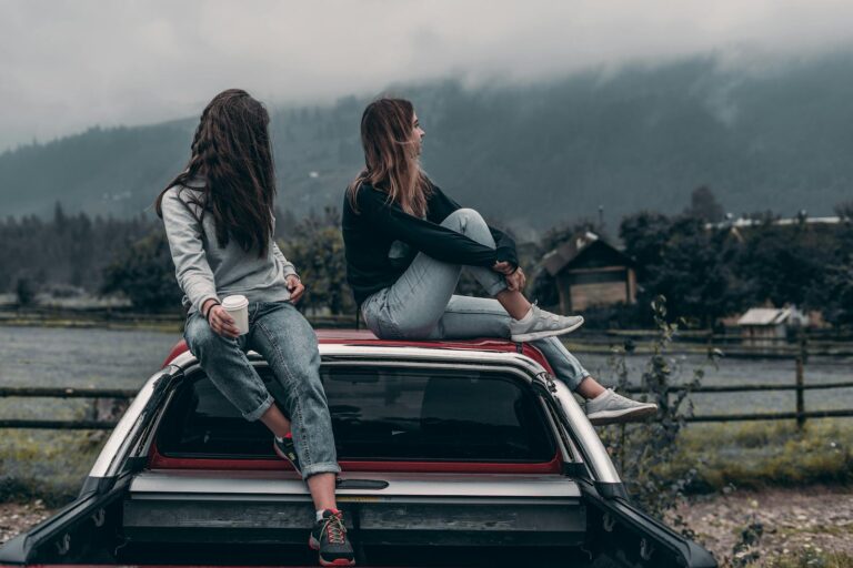 Two women sitting on the vehicle