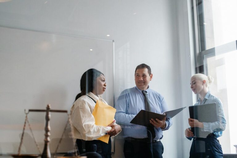 Professional diverse colleagues talking about work in modern office