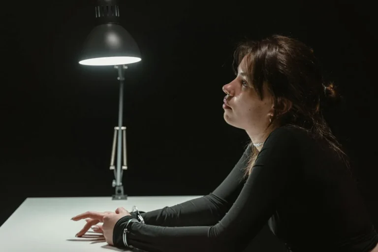 A Woman in Handcuffs Inside an Interrogation Room