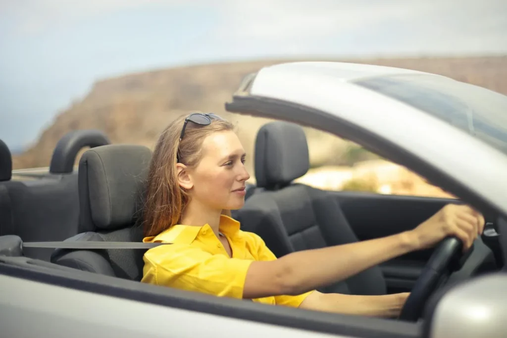 Woman driving a silver car