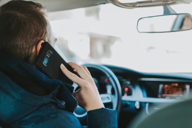 Man tallking on phone while driving a car