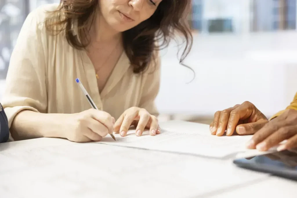 Woman signing divorce agreement