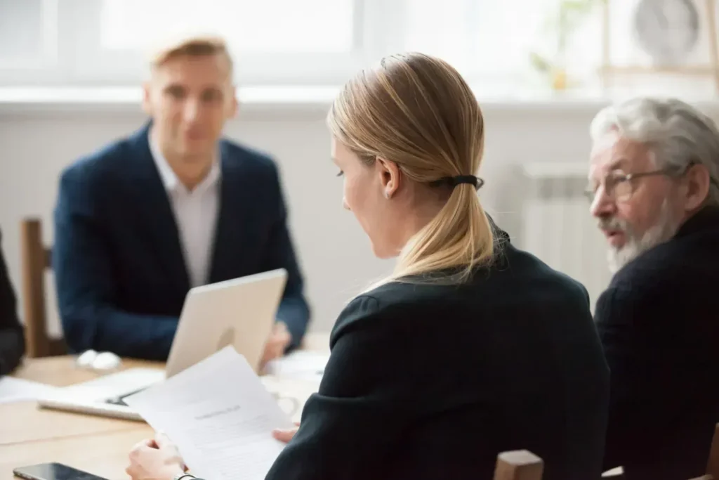 Woman reading divorce agreemeent at a meeting with lawyer