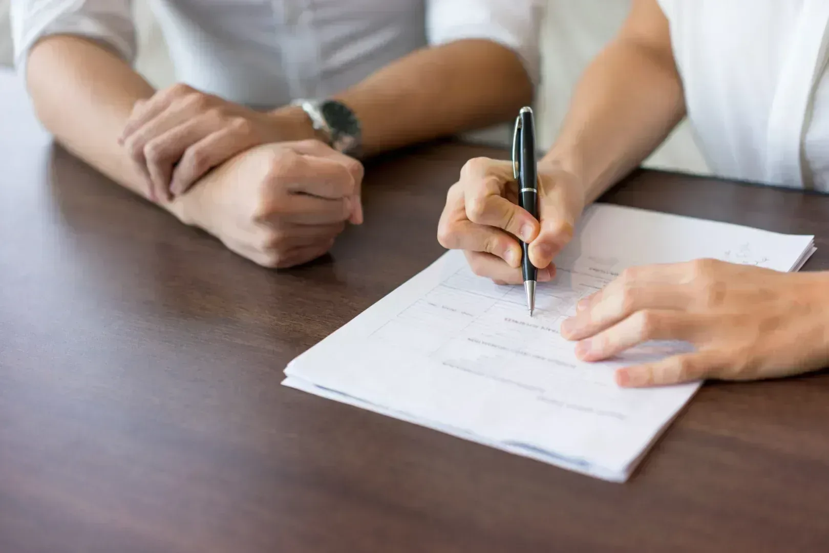 Frightened woman signing documents