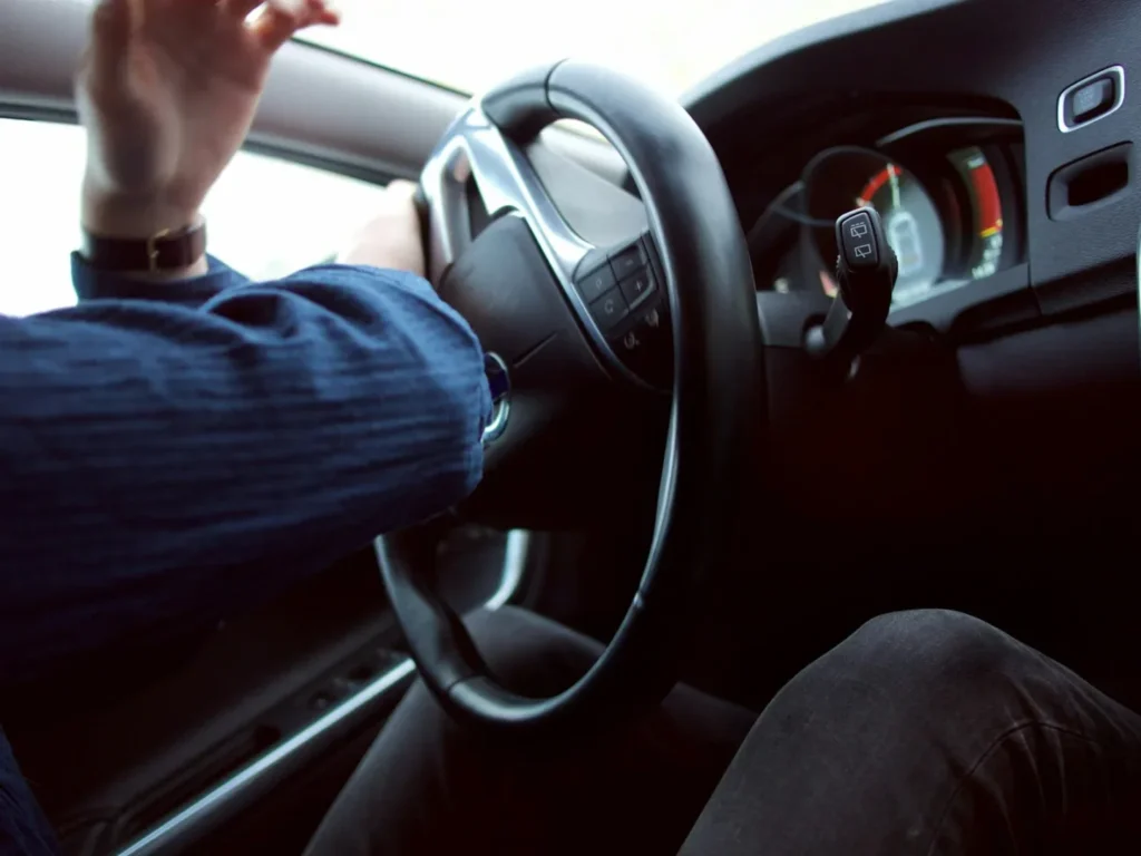 Man holding steering wheel