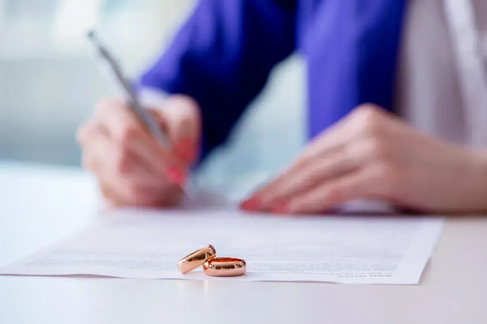 Woman signing divorce papers